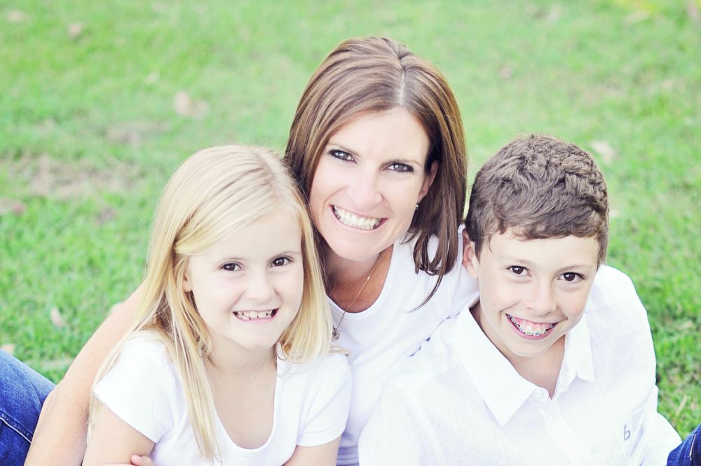 Mum with kids sitting on grass