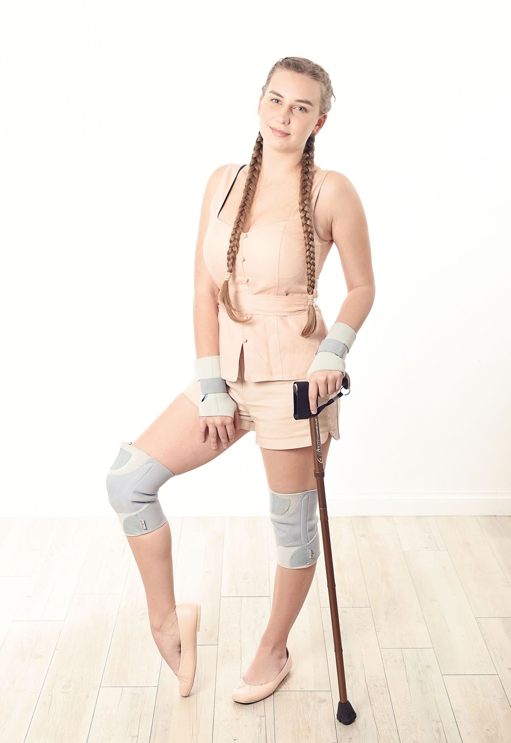 Confident young woman with knee and wrist braces