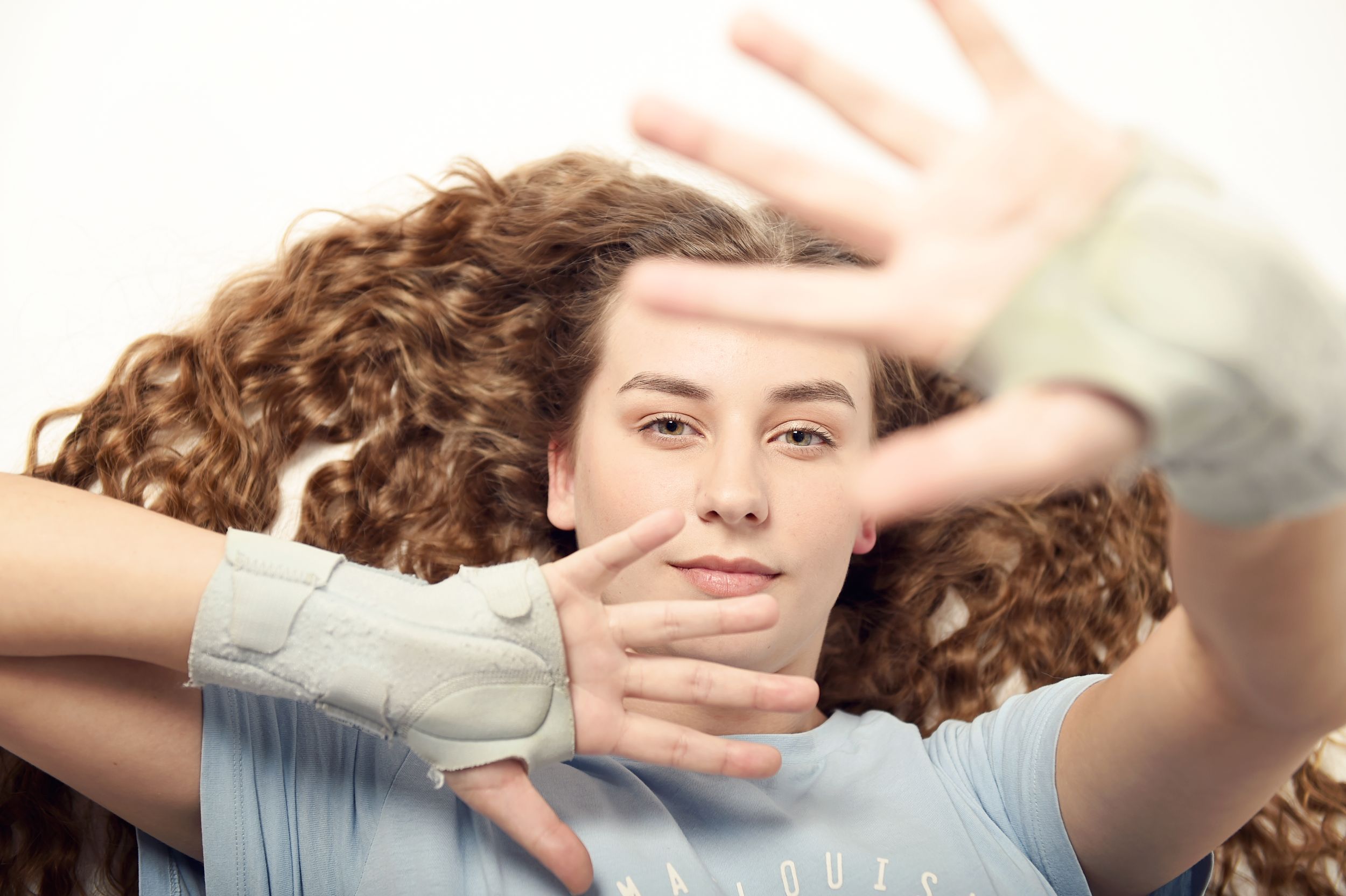 Strong young woman reaching out to the camera
