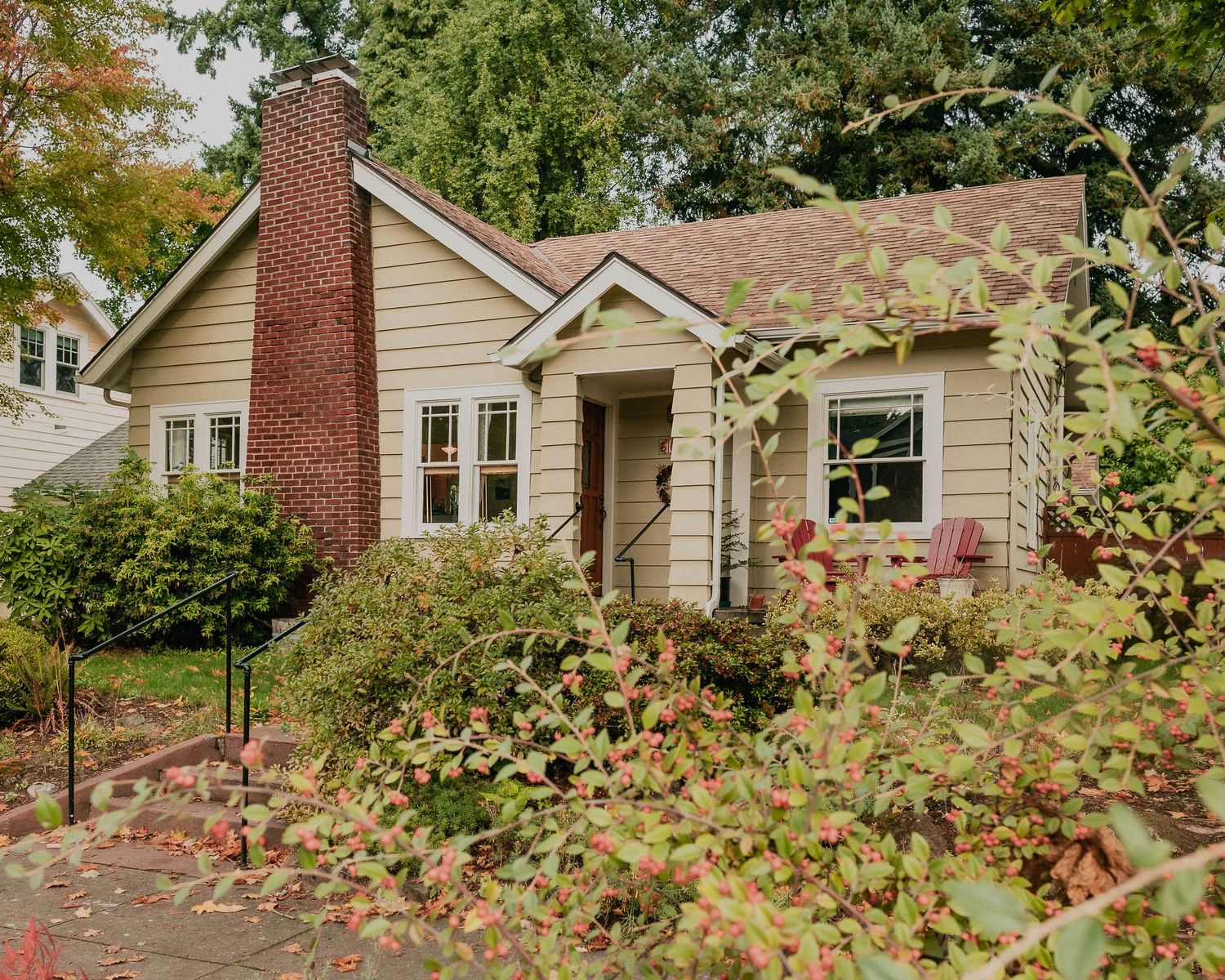 Lovely family home with small front yard, cute brick chimney, and landscaping