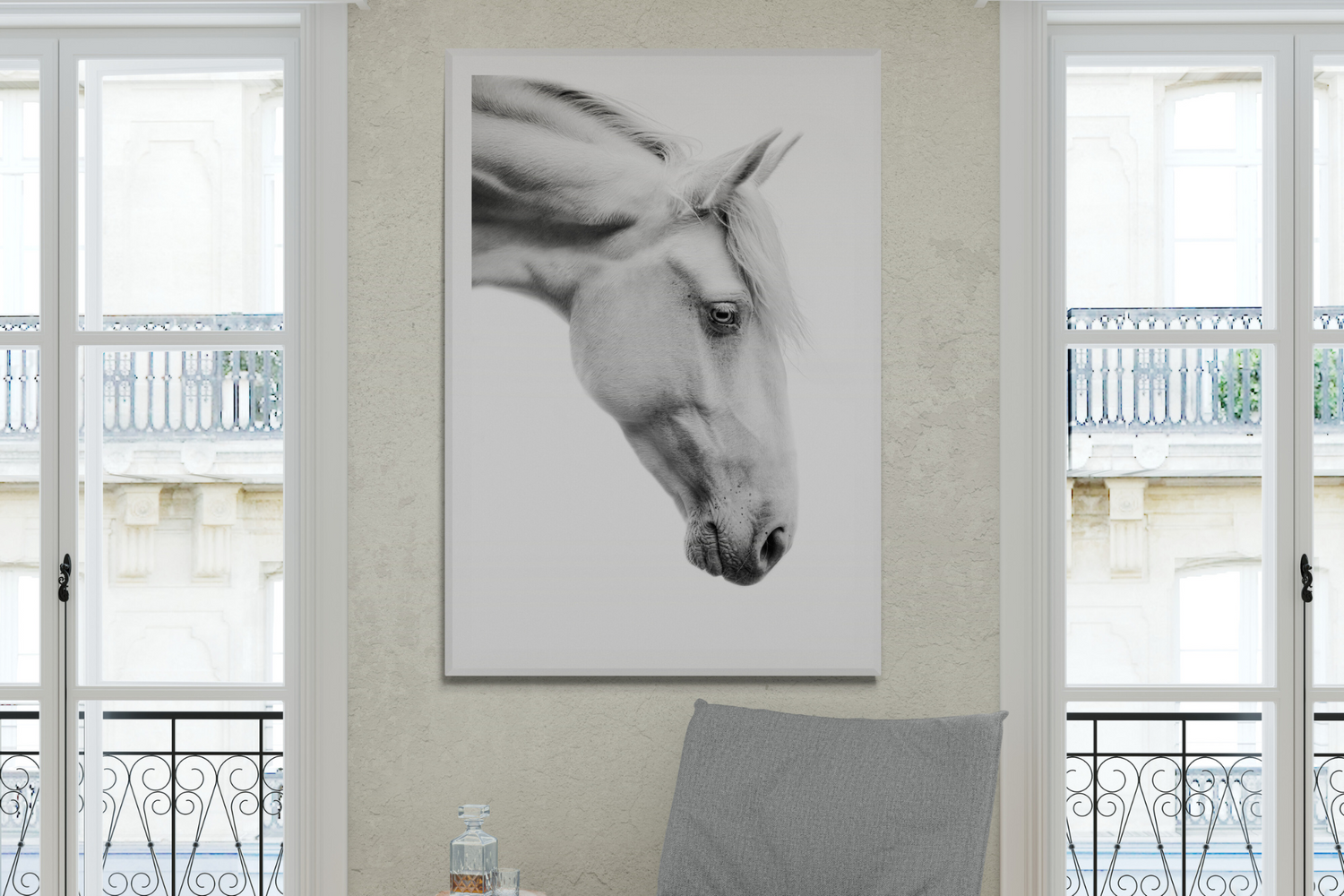 Minimalist black and white horse portrait hanging in bright white Parisian-style room.