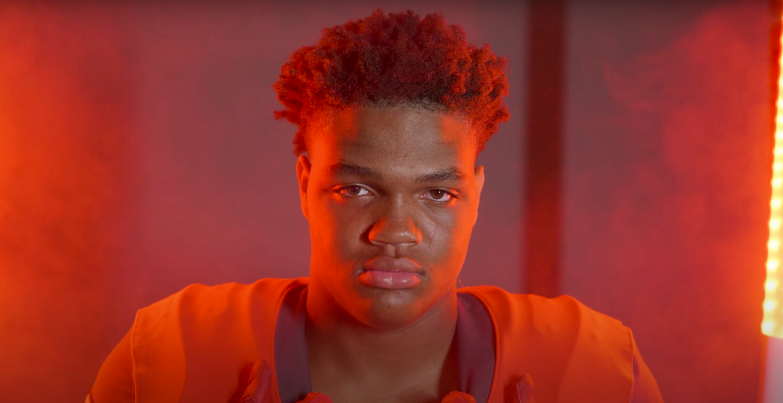 Portrait in orange lighting with dramatic atmospheric effect.