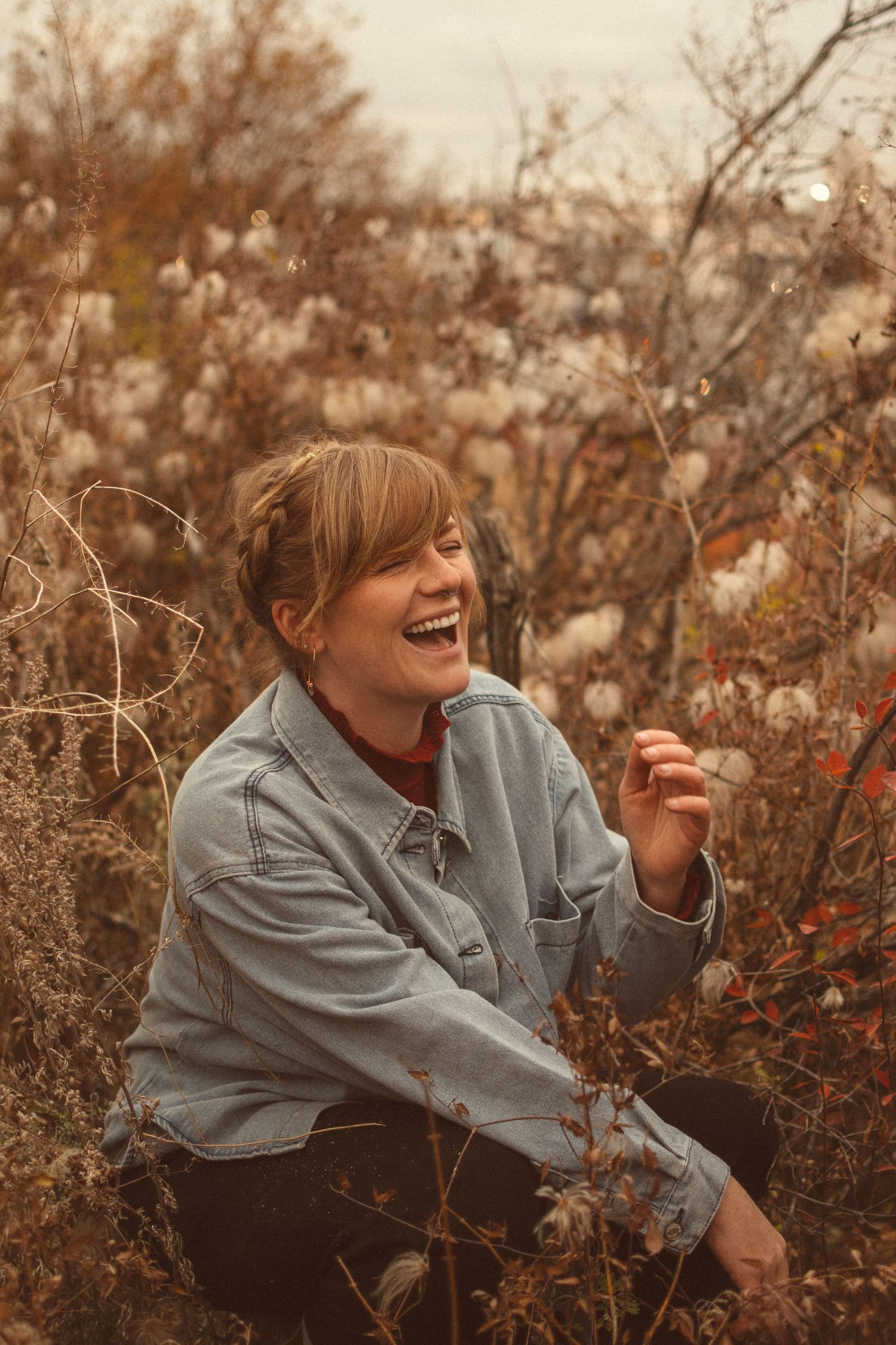 A candid moment of joy captured in autumn foliage with warm golden tones.