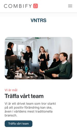 Office team meeting scene with people discussing in a modern bright workspace.