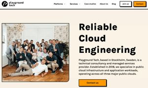 Corporate team photo of Playground Tech staff gathered together in casual office setting.