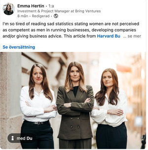 Three professional businesswomen pose together against a light background wearing business attire.