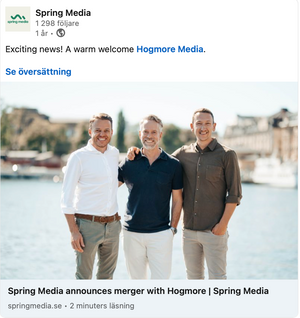 Three business professionals standing together at a waterfront location.