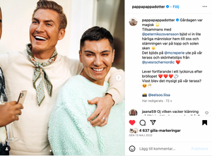 Two friends in light colored outfits embrace and laugh together in a social media post.
