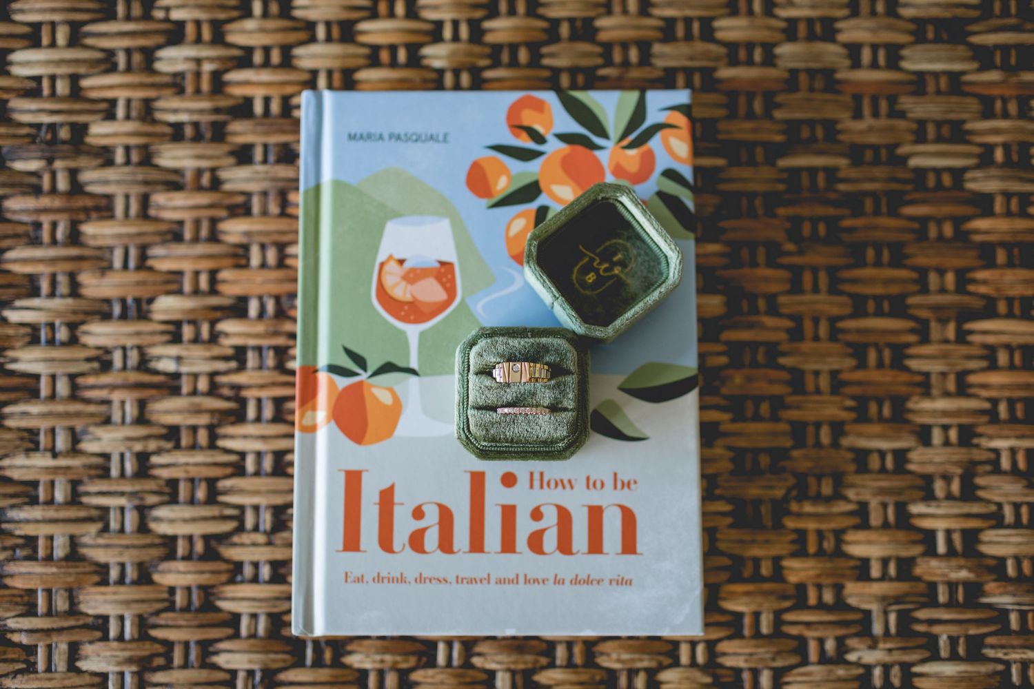 An Italian cookbook displayed on a woven wicker surface.