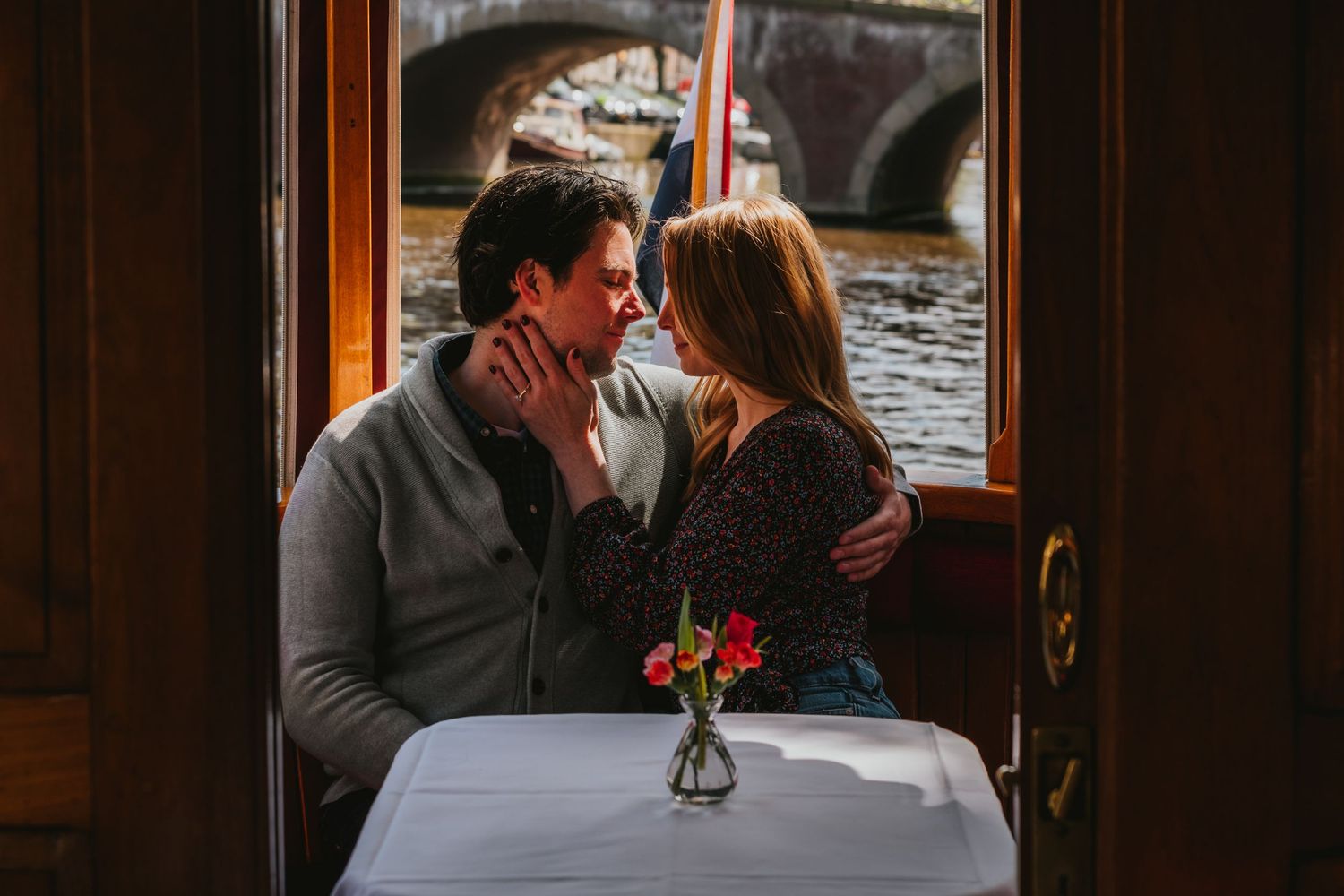 Engaged couple who had proposal in Amsterdam are sharing romantic moment in boat.