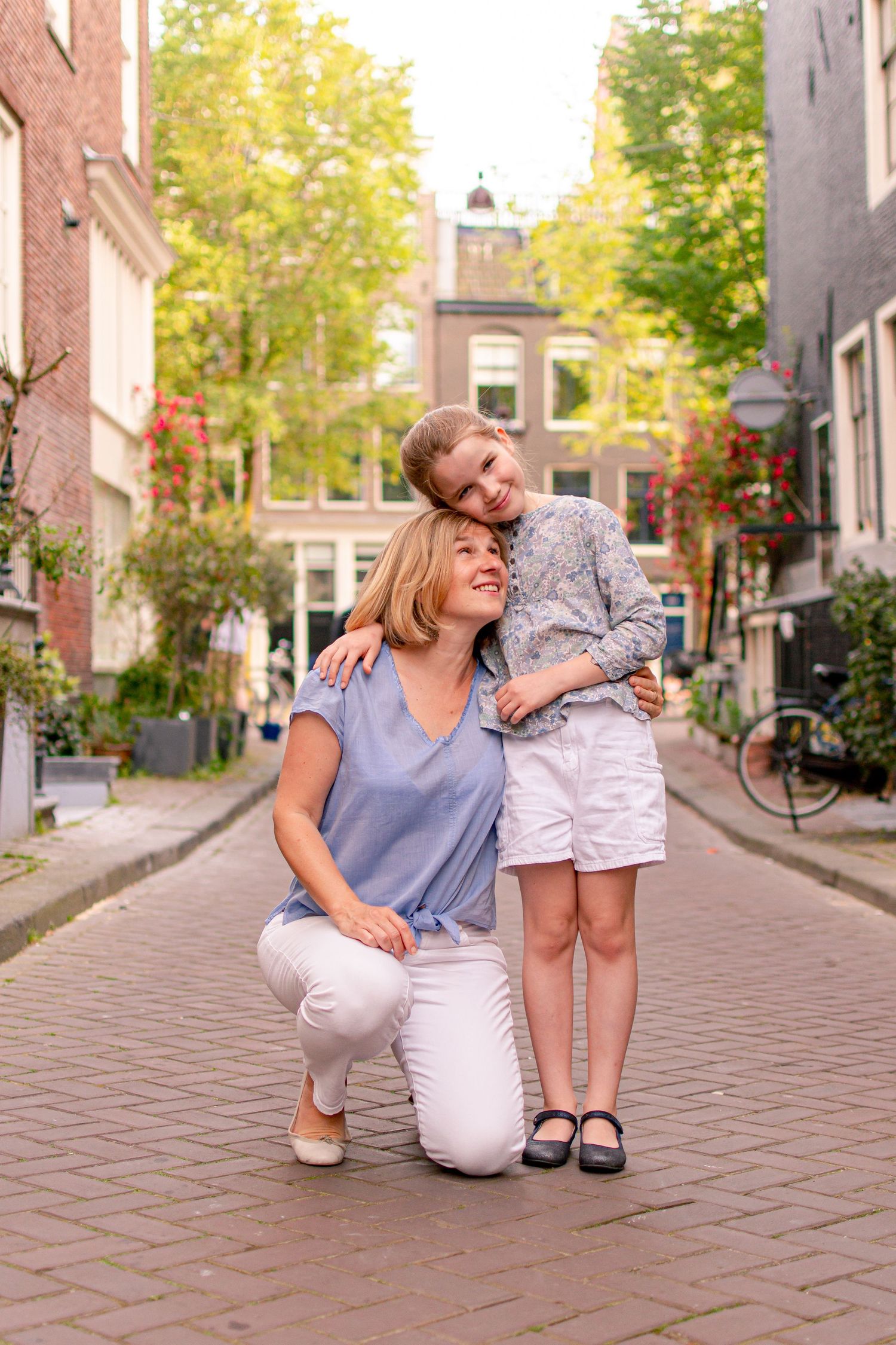 Mother and daughter hugging in a street in Amsterdam.