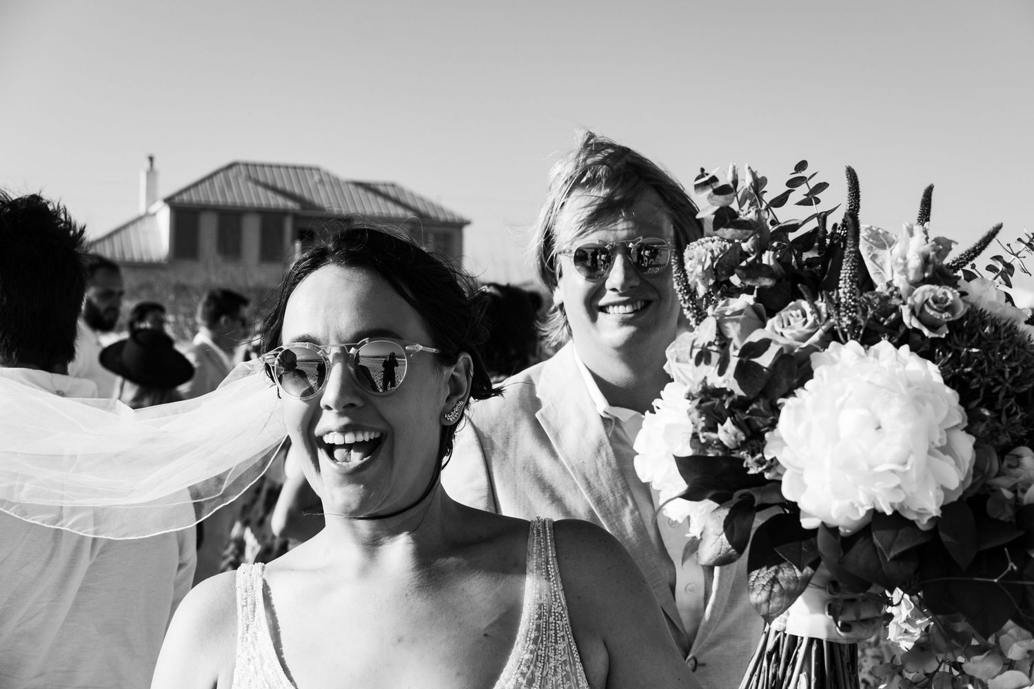 Black and white photo of joyful wedding celebration.