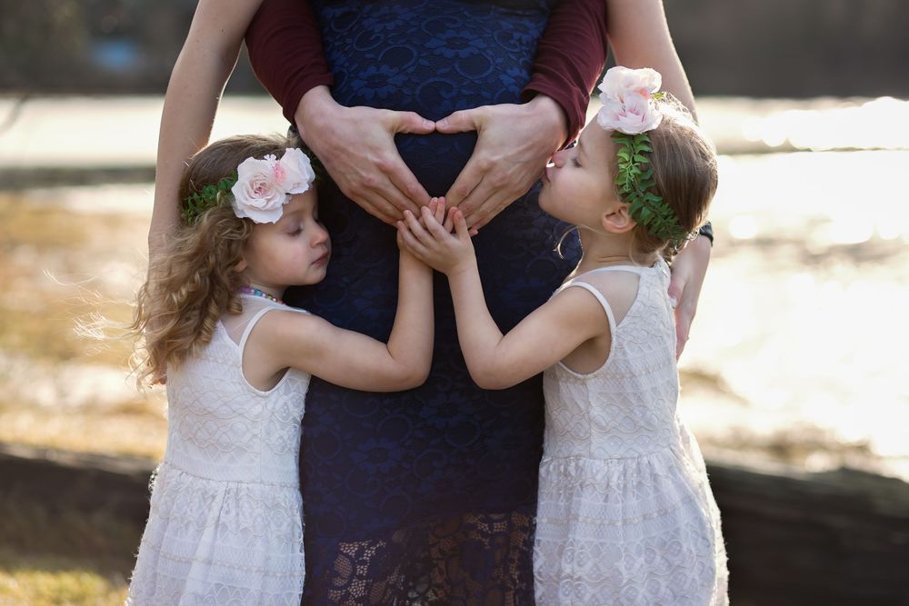 This family is giving baby in mama's tummy some love.