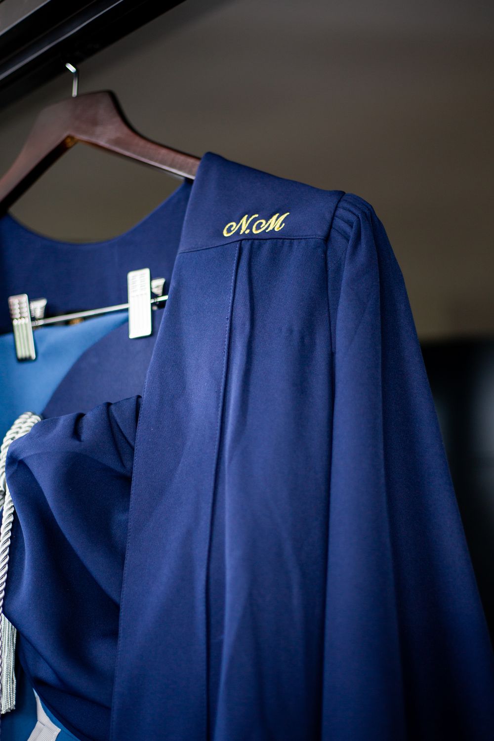 Graduation photography, graduation shoot with a degree certificate, wearing gowns and holding their degrees.