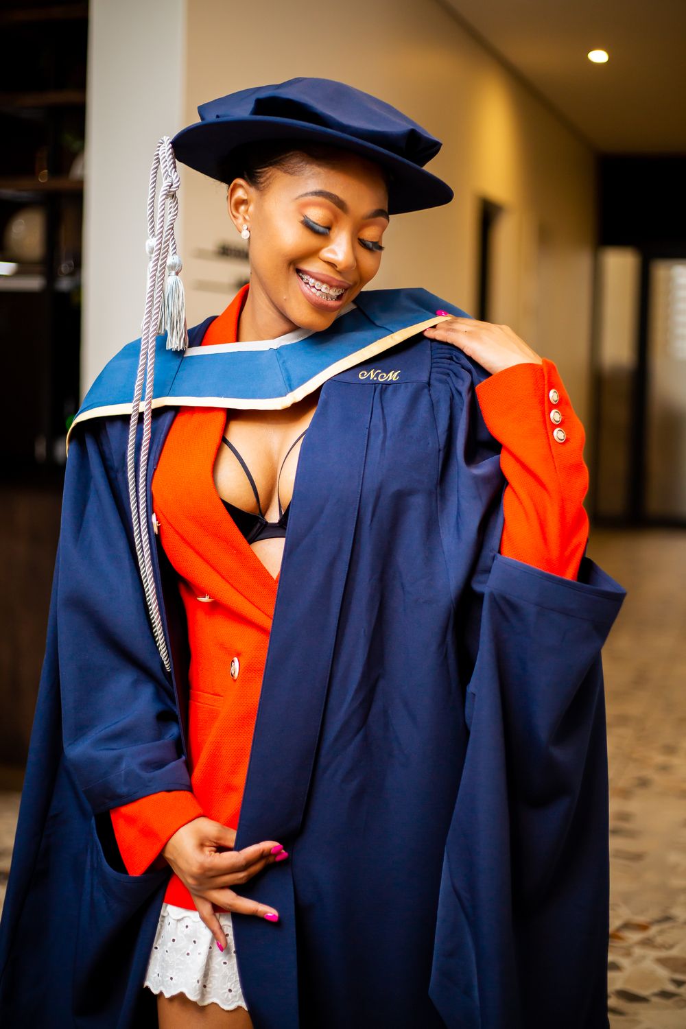 Graduation photography, graduation shoot with a degree certificate, wearing gowns and holding their degrees.