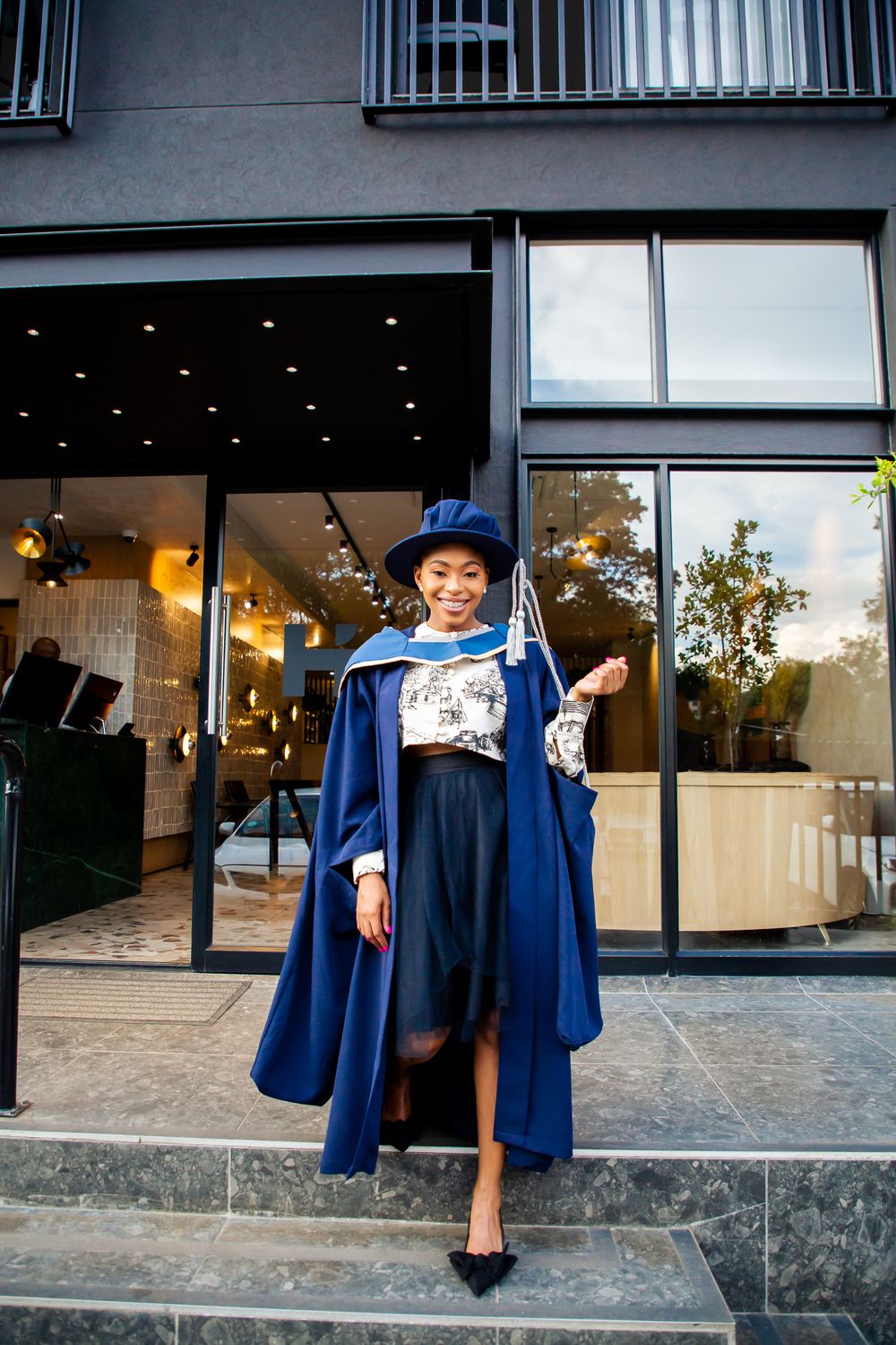 Graduation photography, graduation shoot with a degree certificate, wearing gowns and holding their degrees.