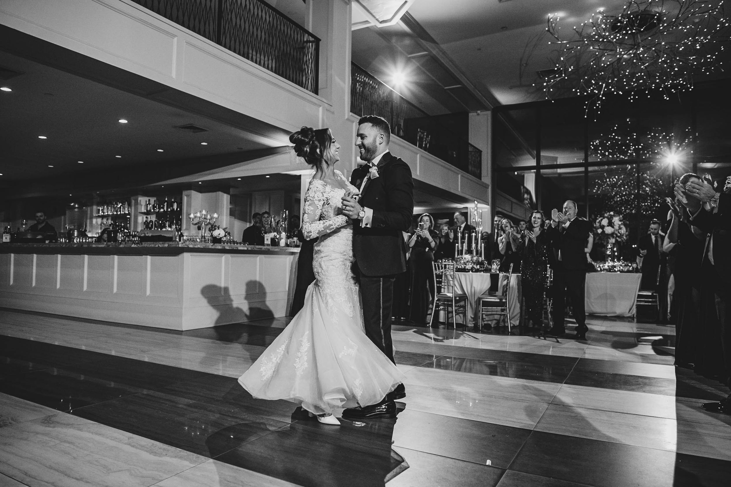 Black and white photograph of dancing in an elegant ballroom setting.