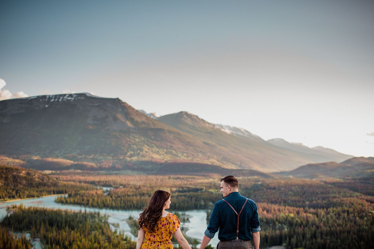 A couple stares out onto the mountain ranges near Jasper Alberta