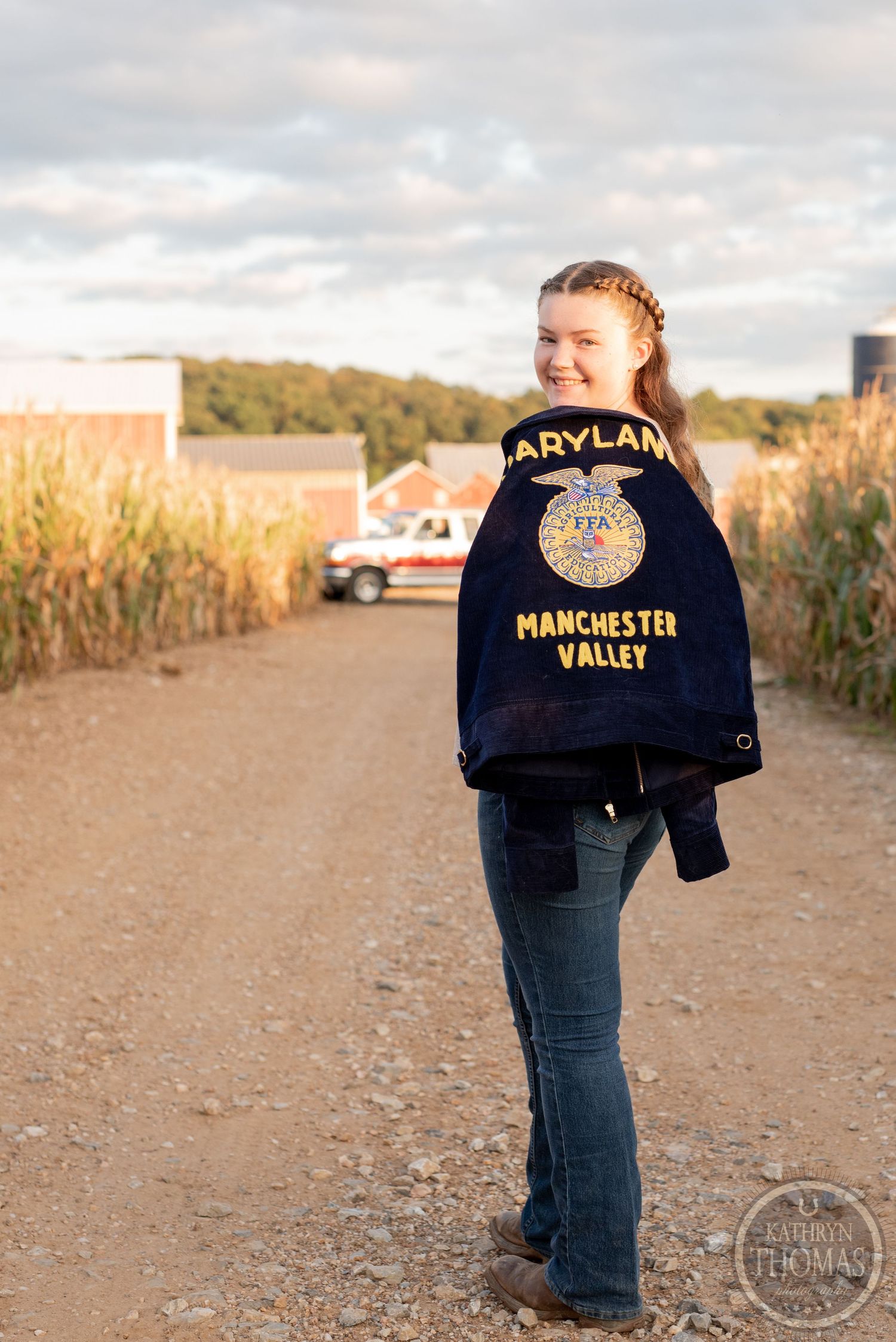 Wearing a Manchester Valley FFA jacket while standing on a path between cornfields.