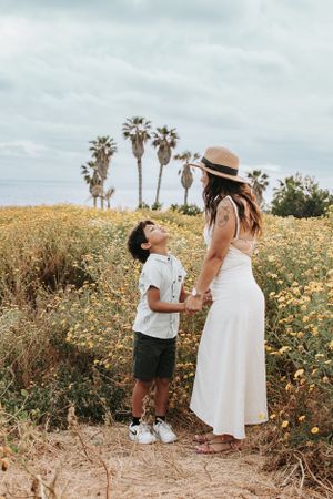 A sweet moment between parent and child in a coastal wildflower field.