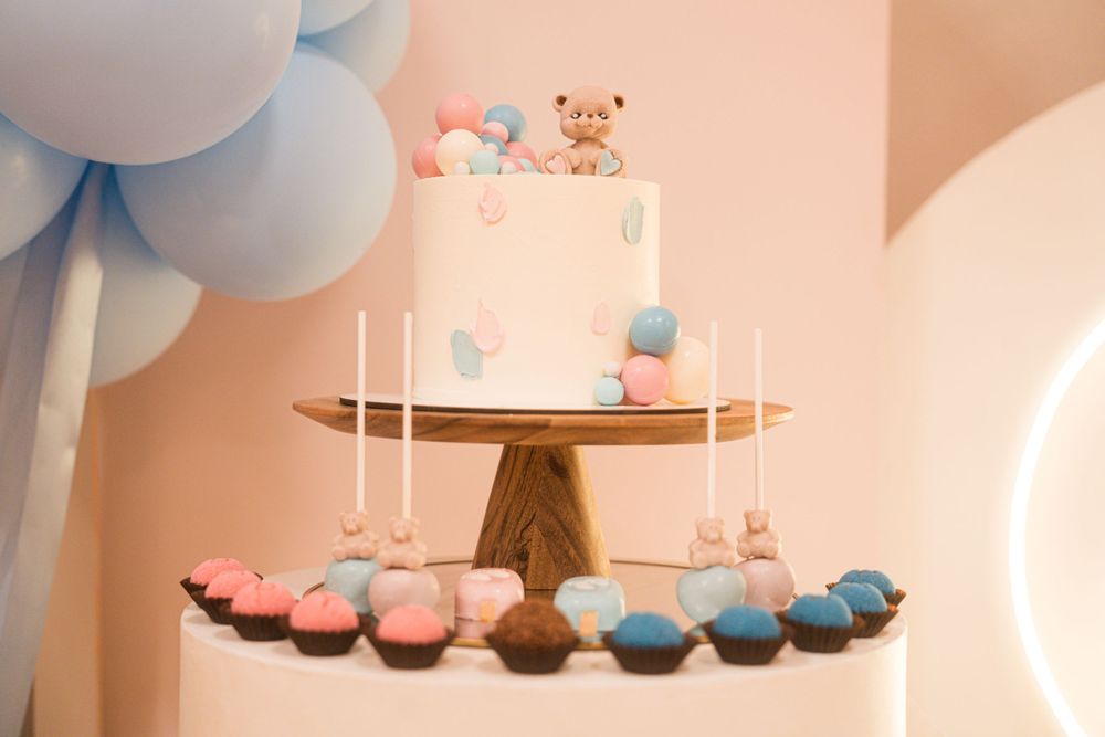 Baby shower party setup with hanging decorations and themed treats display.