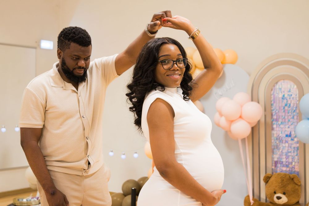 Couple sharing a special moment during their baby gender reveal celebration.