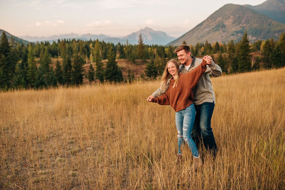 A joyful moment shared in a golden mountain meadow during sunset.