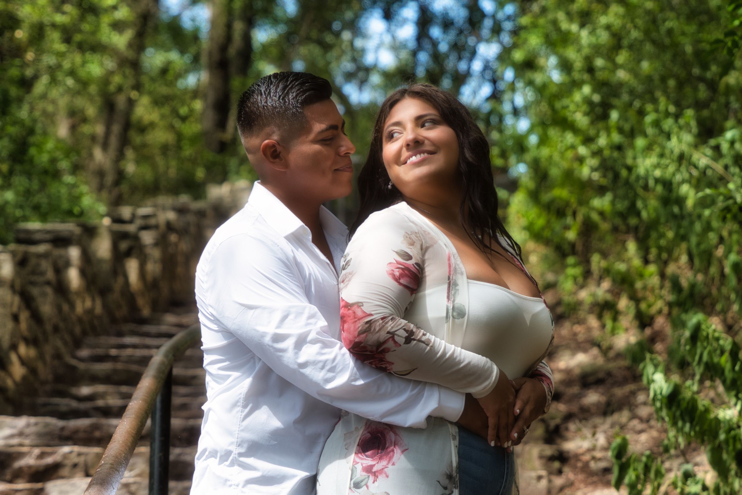 man holds woman from behind