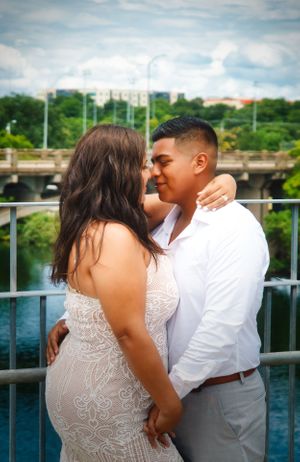 couple holding each other in front of a lake