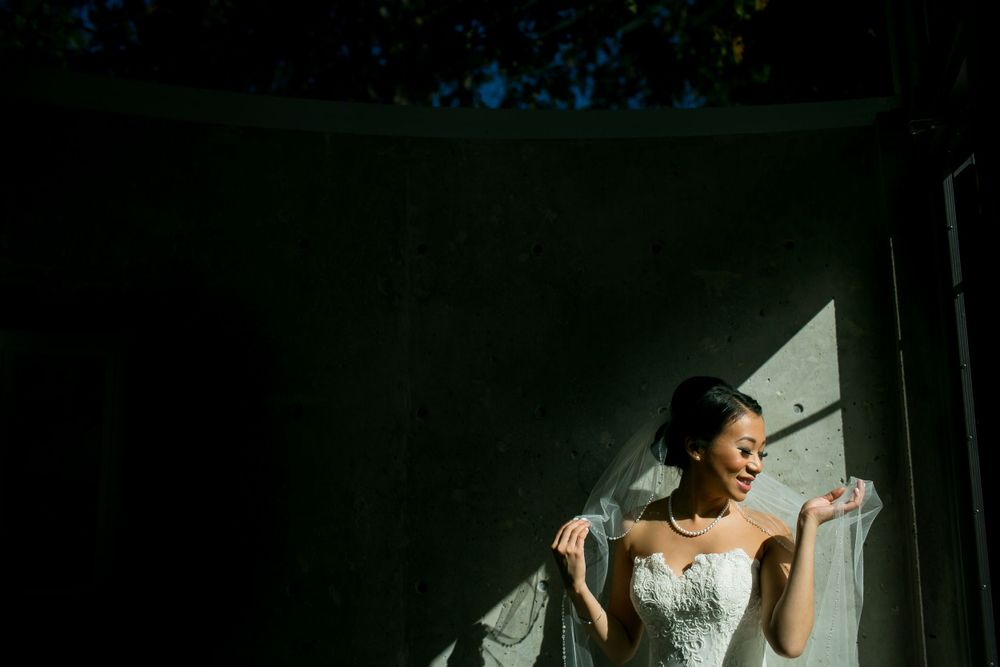 Dramatic side-lit portrait in preparation room with strong contrast lighting.
