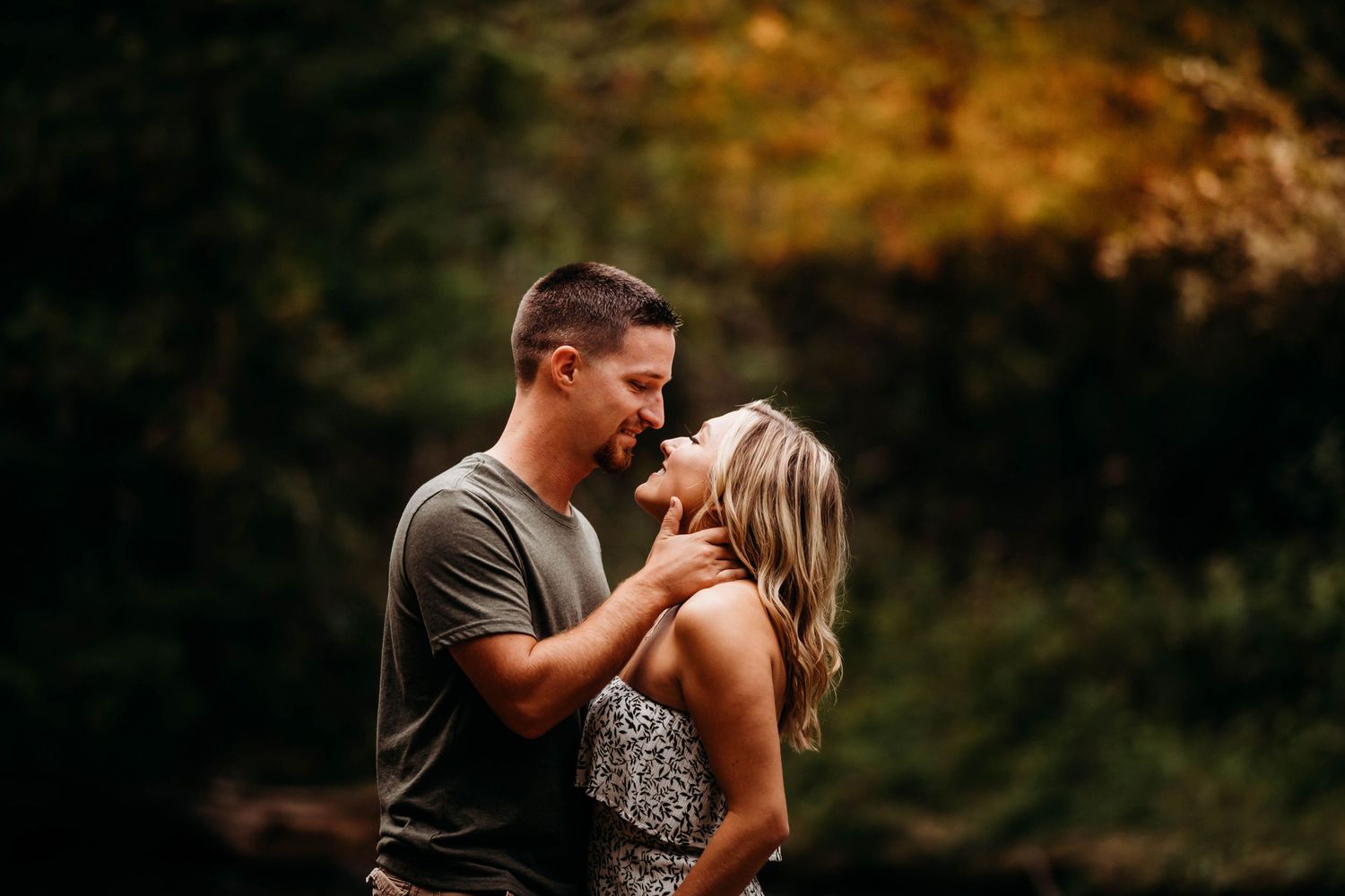 Two people share a romantic moment in a warm autumn evening setting.