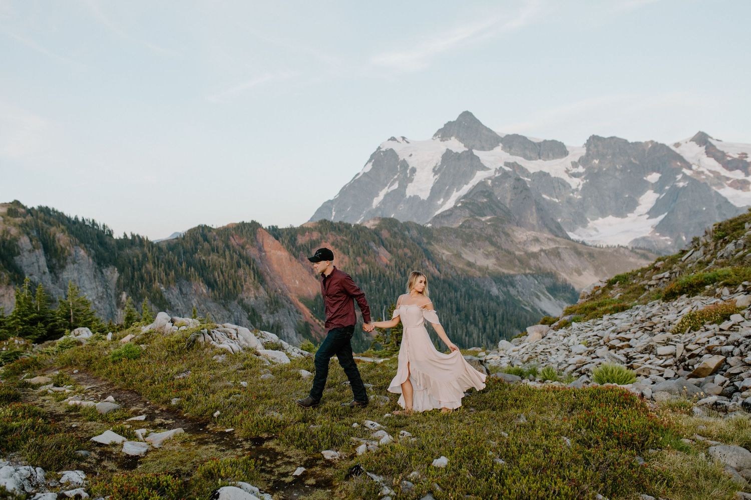 Adventure wedding photography in dramatic mountain landscape with snow-capped peaks.