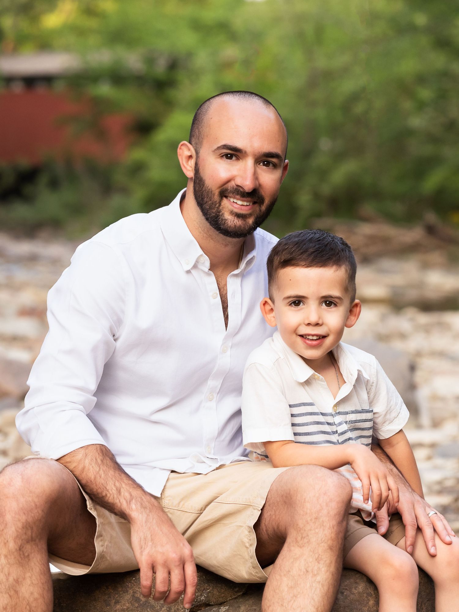 father and son sitting on rock summer portrait family photography