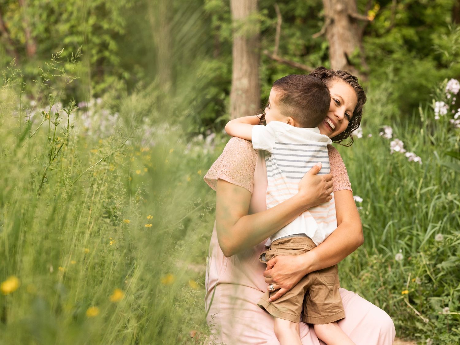 mother son embrace during family maternity photos