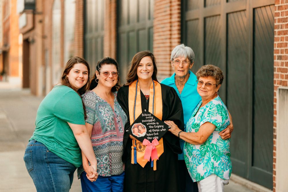 Family group photo session against brick building exterior.