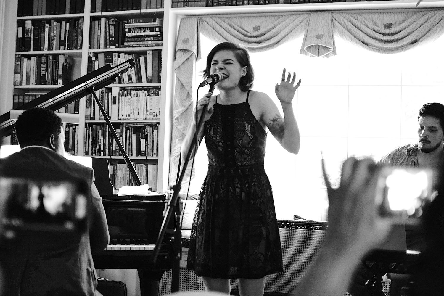 Black and white photos of performers singing in an intimate venue setting.