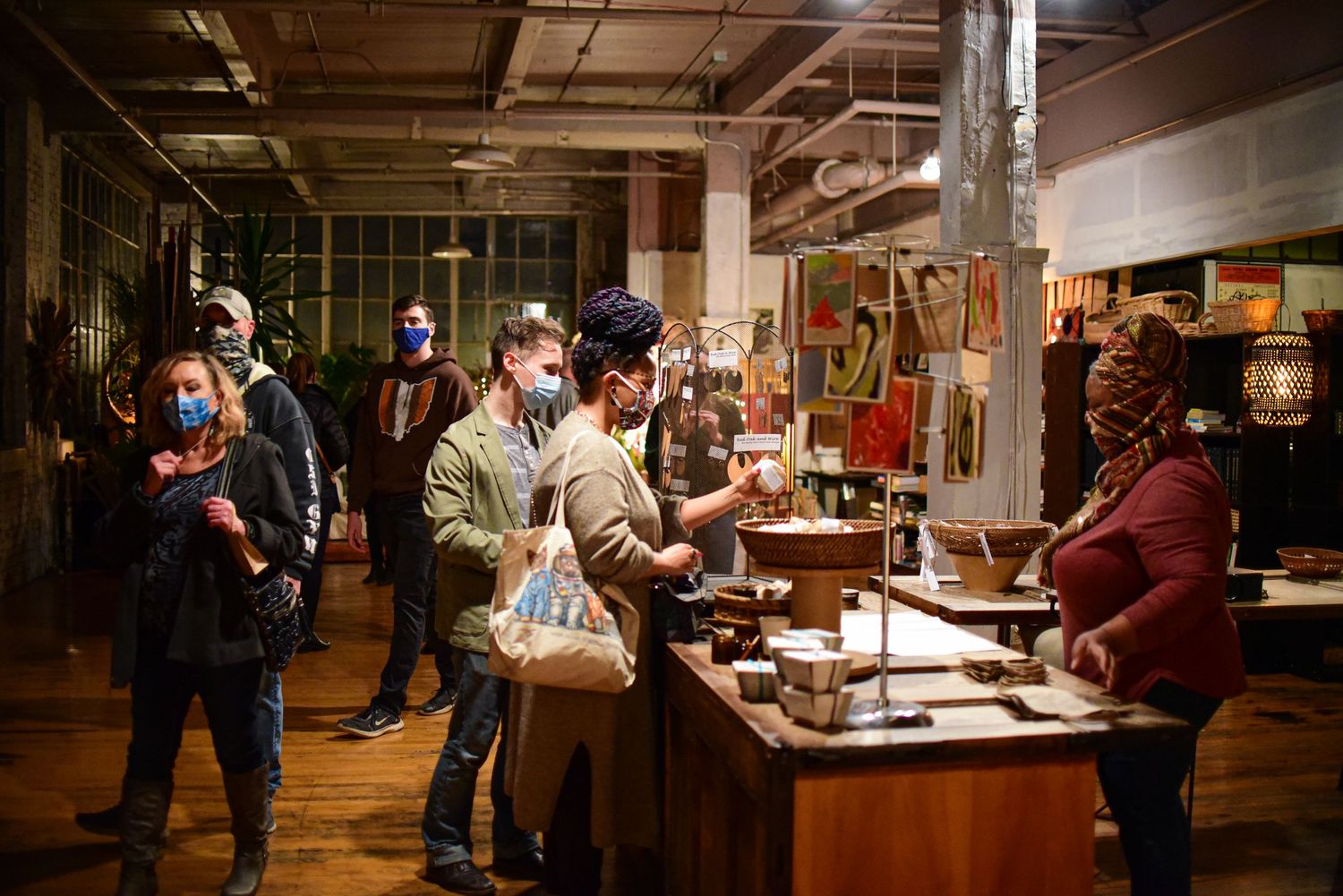People browsing displays in dimly lit gallery or exhibition space.