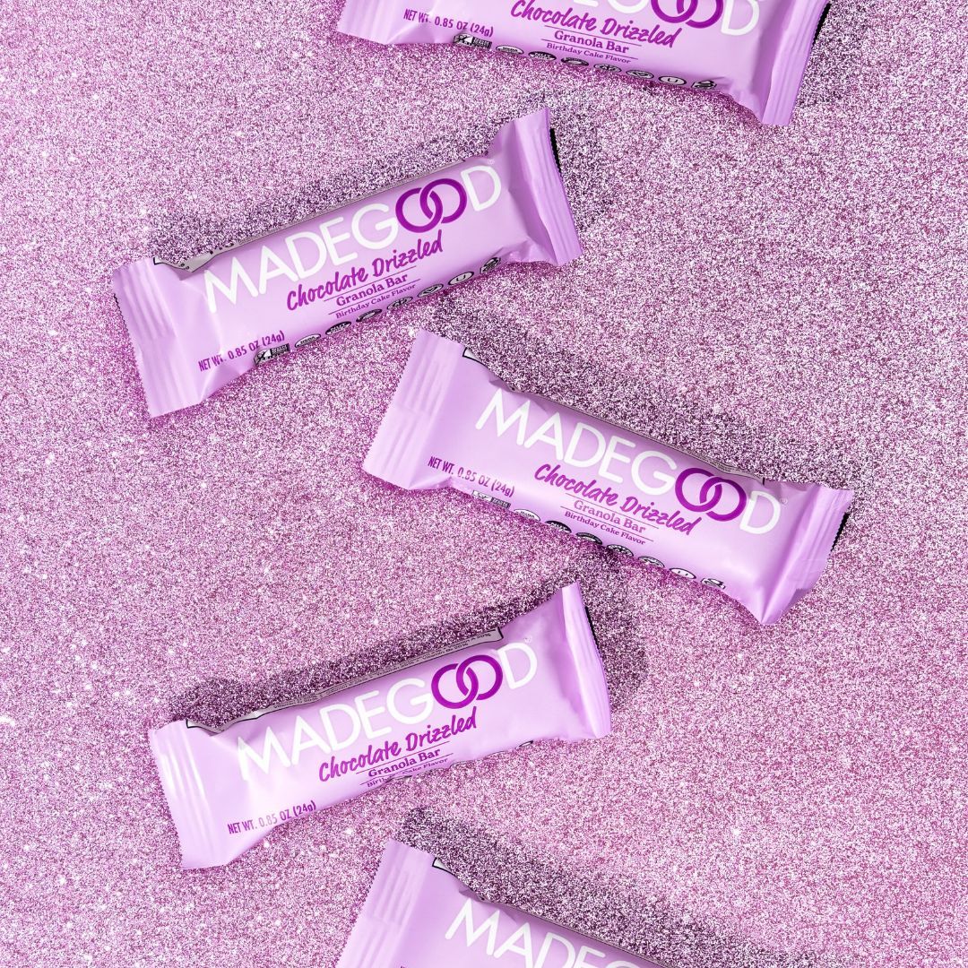 Pink marriage protein bars scattered on sparkly pink glitter surface.