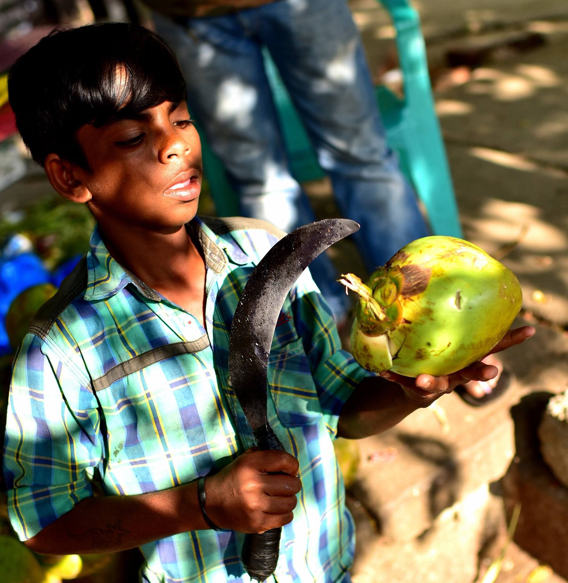 A child coconut vendor in Bangalore, India