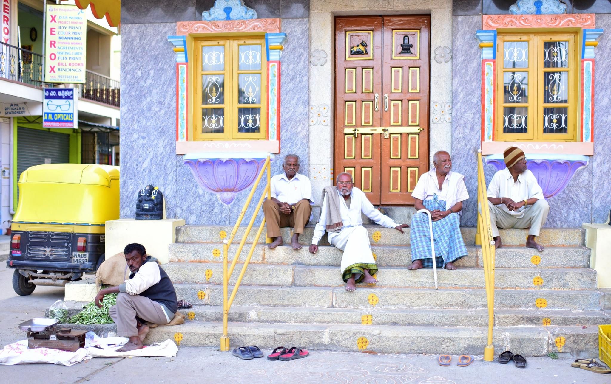 Men sitting on the steps of a building in Bangalore, India