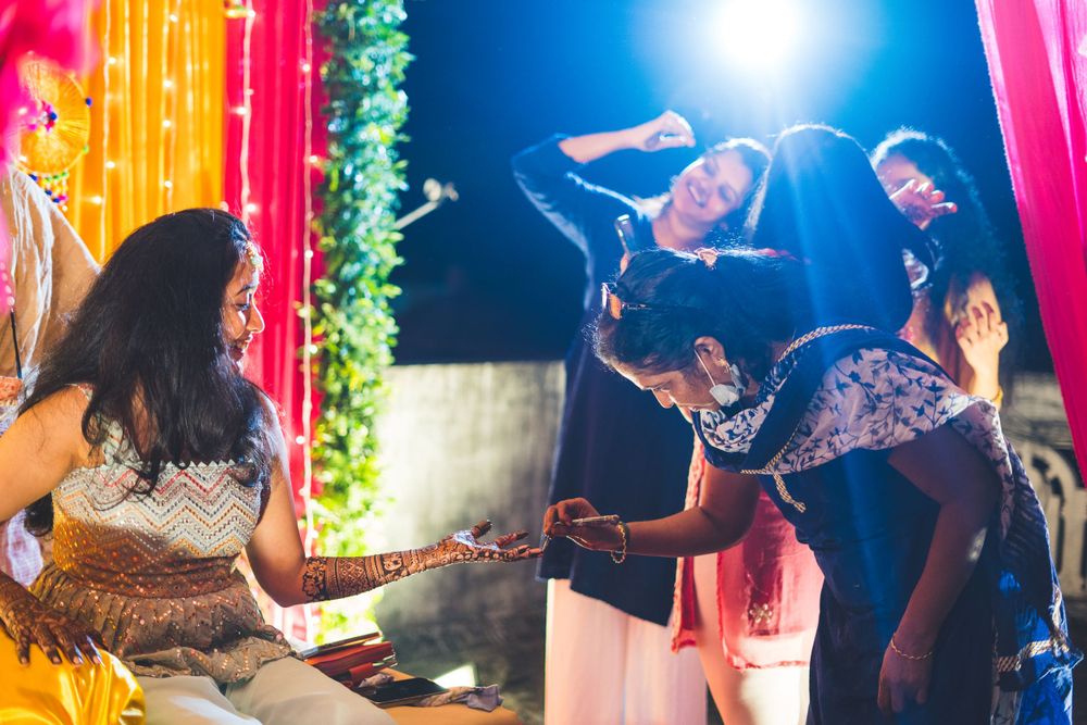 Festive Indian wedding dance performance with colorful lighting and decorations.