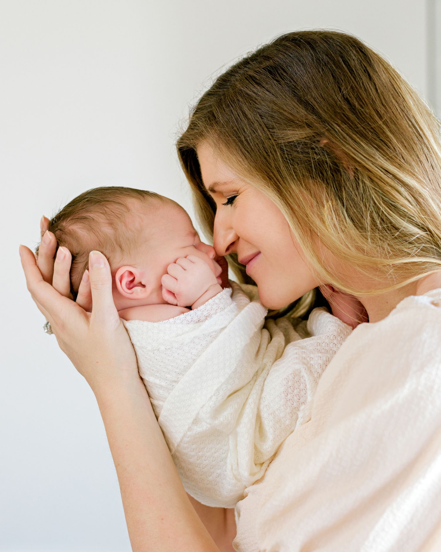 Intimate newborn portrait captured in soft, dreamy natural light.