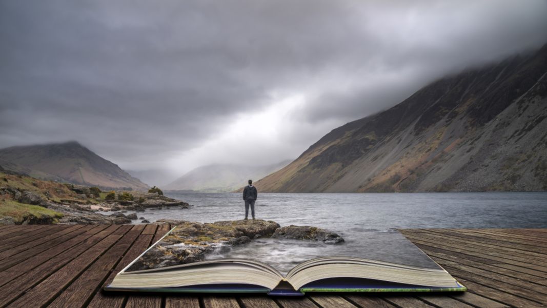 Story book opening up to mountains, sea and sky with groom overlooking earth