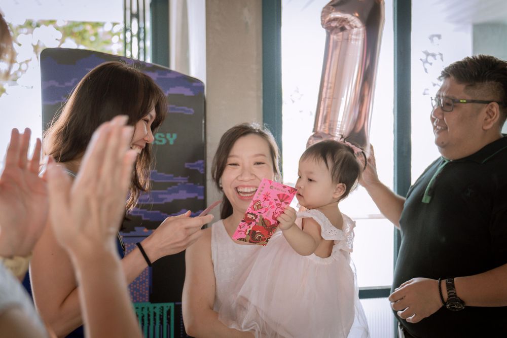 A lively celebration moment with party decorations and balloons in the background.
