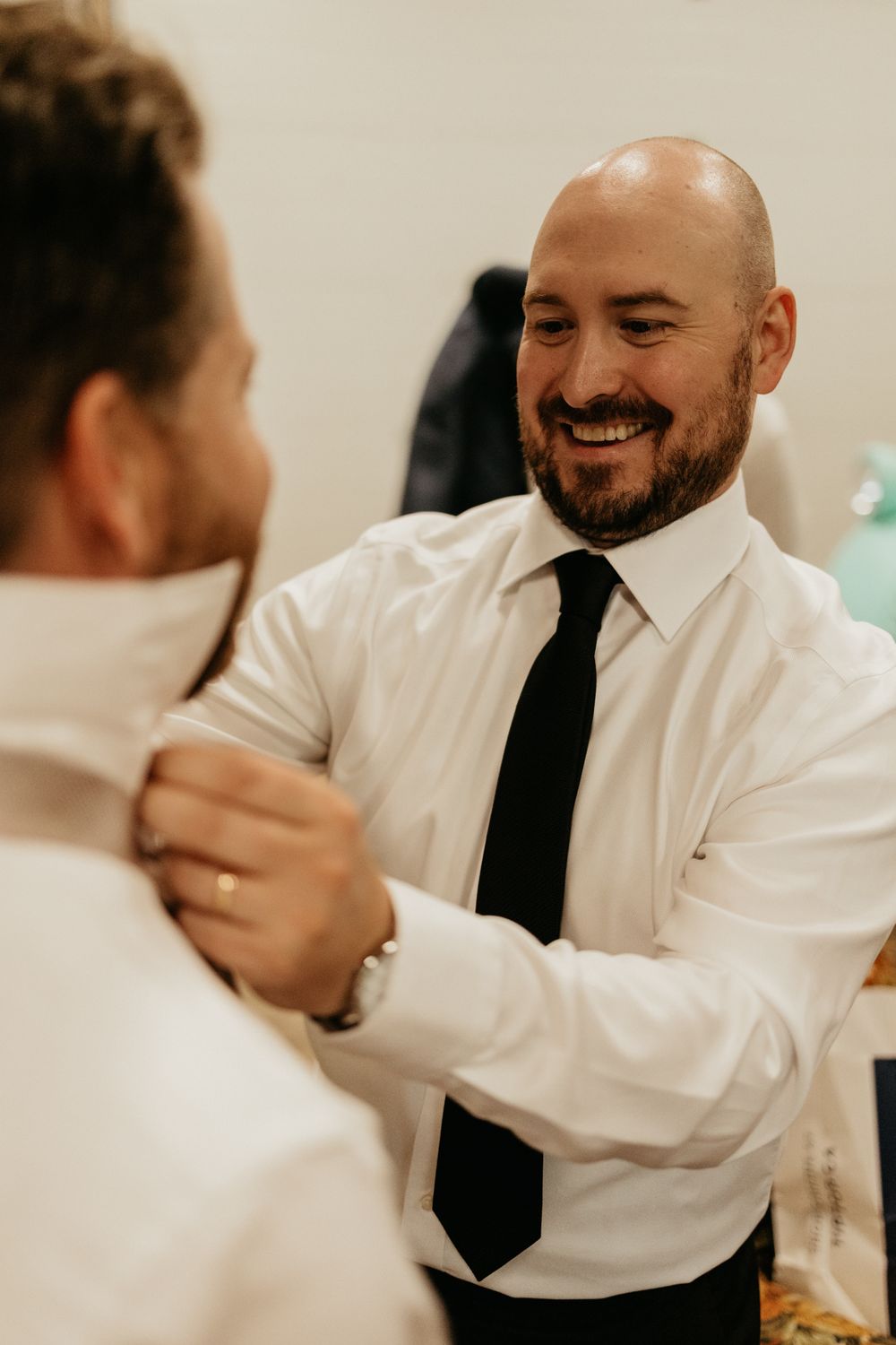 People in formal attire enjoying conversation at social event.