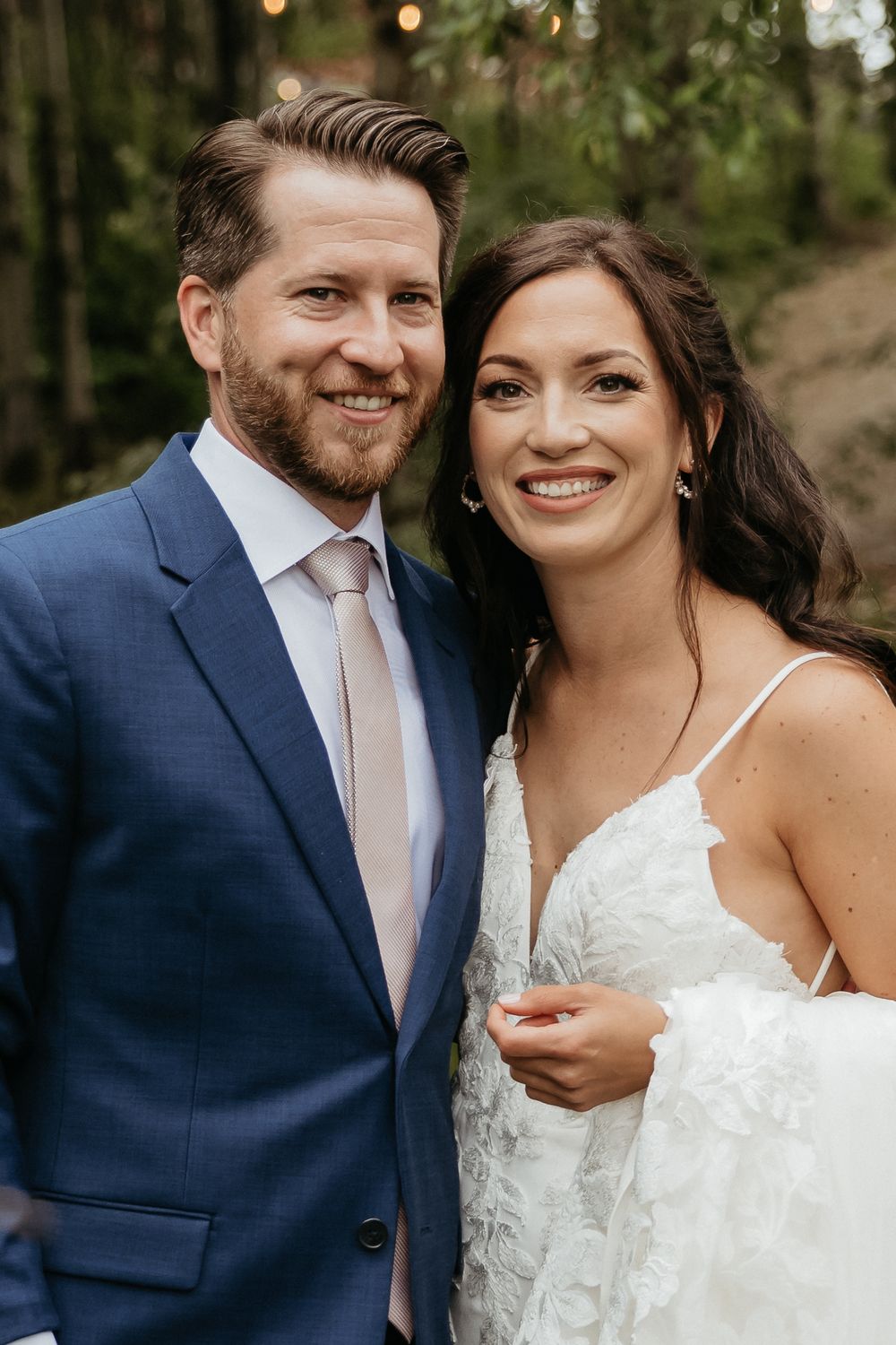 A happy couple shares intimate moments together during their outdoor wedding photoshoot.