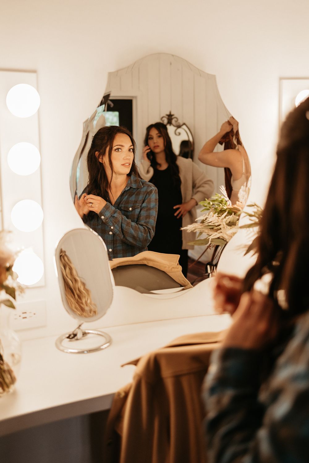 Vanity mirror setup with bright lighting in dressing room.