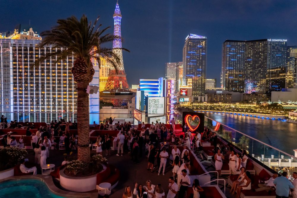 Las Vegas Strip nighttime view with crowds at outdoor venue.