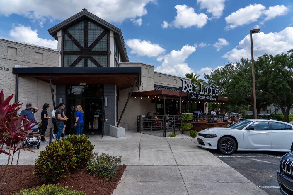 Restaurant exterior with Tudor-style architecture and parked cars out front.
