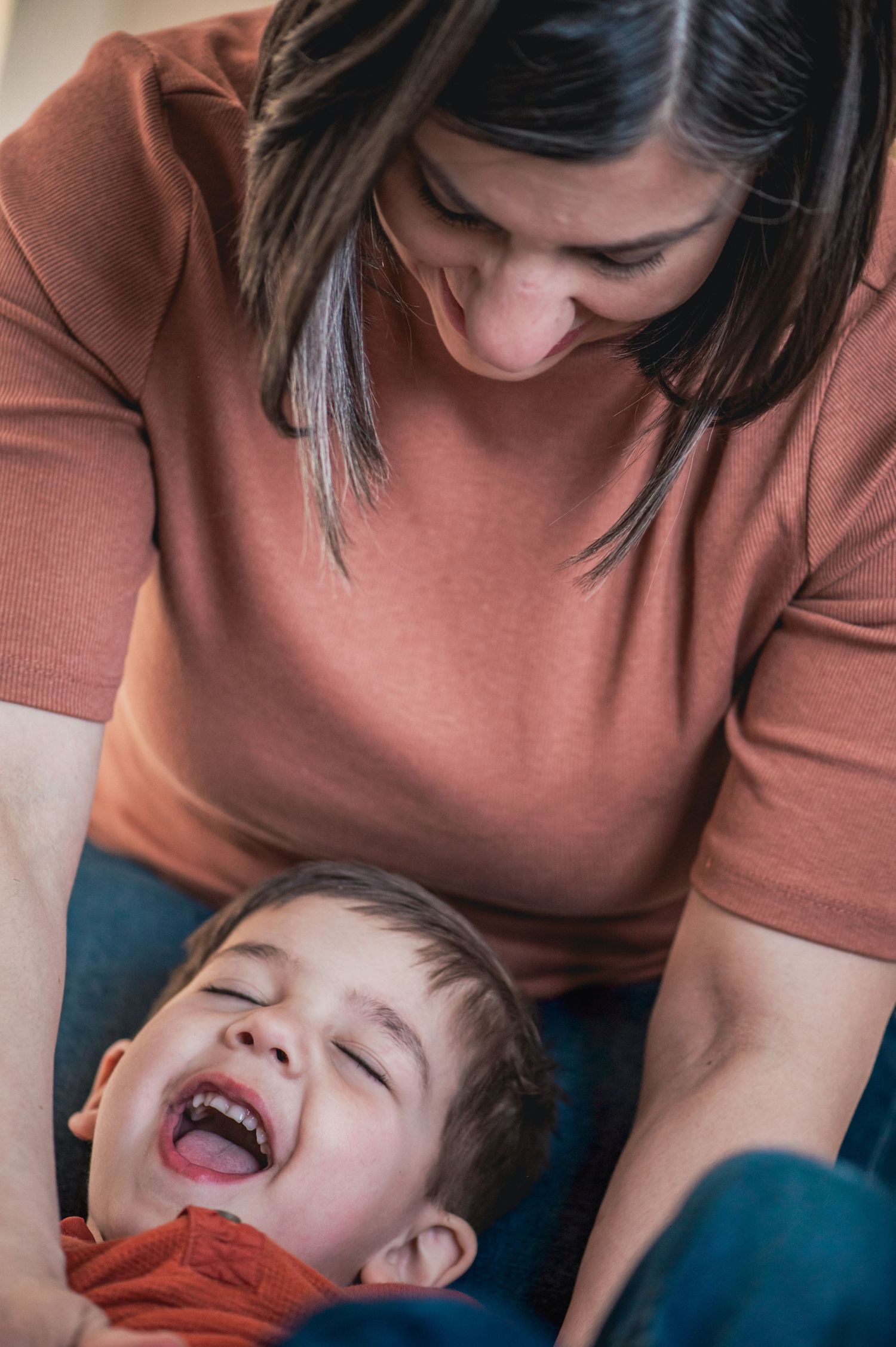 Candid moment of joyful interaction between parent and child.